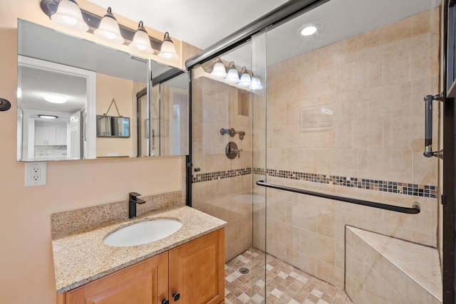 bathroom with vanity and a shower stall