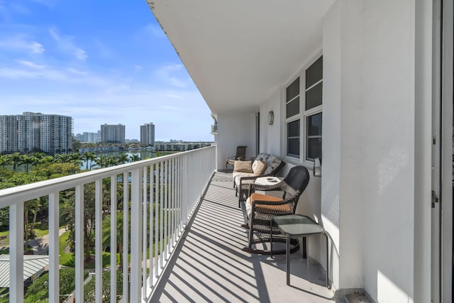 balcony with a water view and a city view