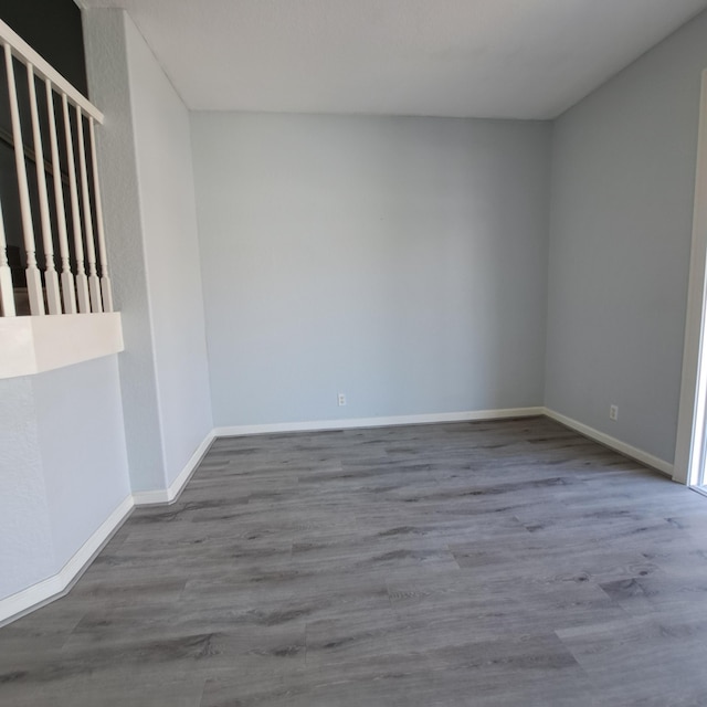 spare room with wood finished floors and baseboards