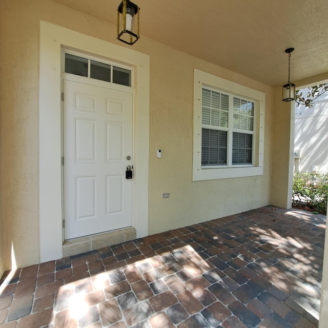 doorway to property with stucco siding