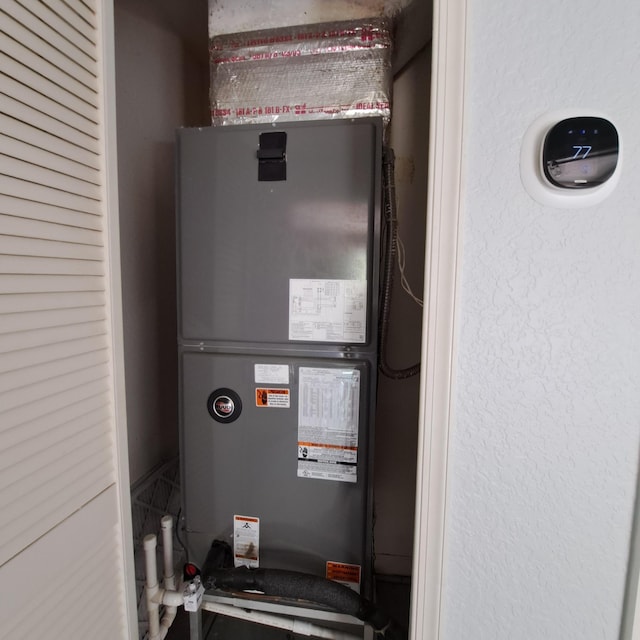 utility room featuring heating unit