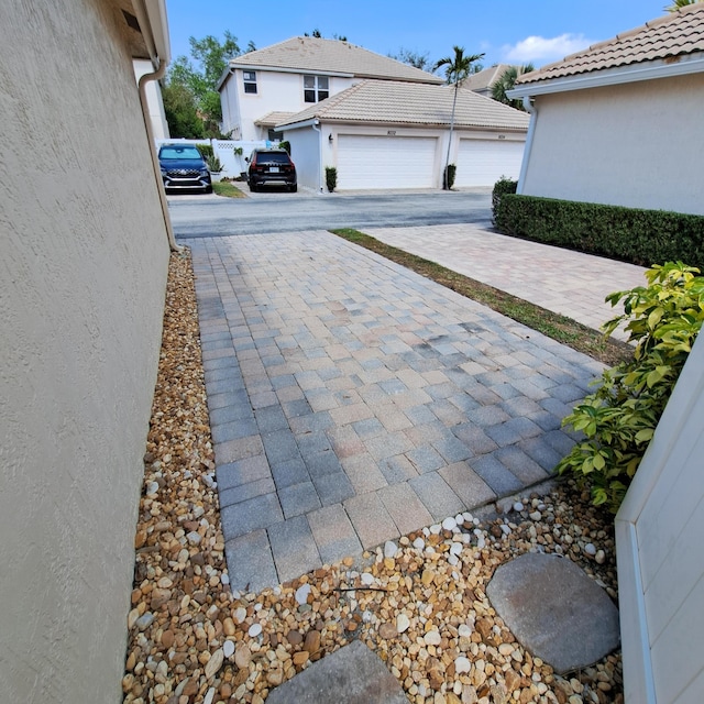 exterior space featuring a garage and decorative driveway