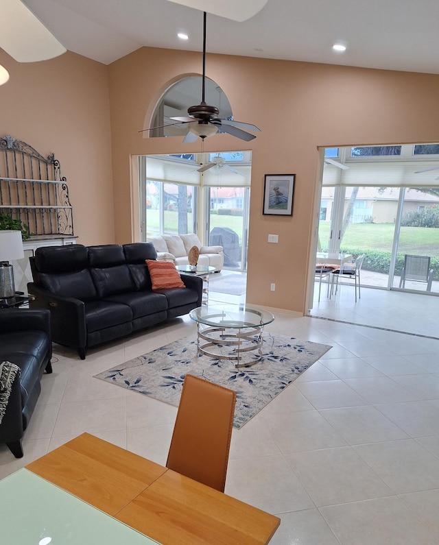 tiled living room with recessed lighting, high vaulted ceiling, and ceiling fan