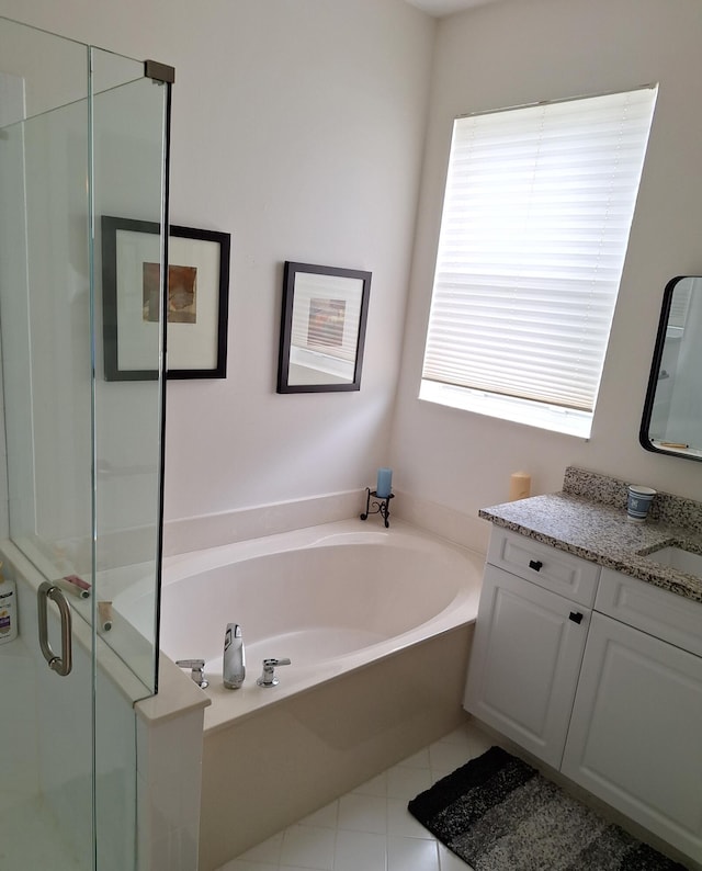 bathroom featuring vanity, a garden tub, a stall shower, and tile patterned floors