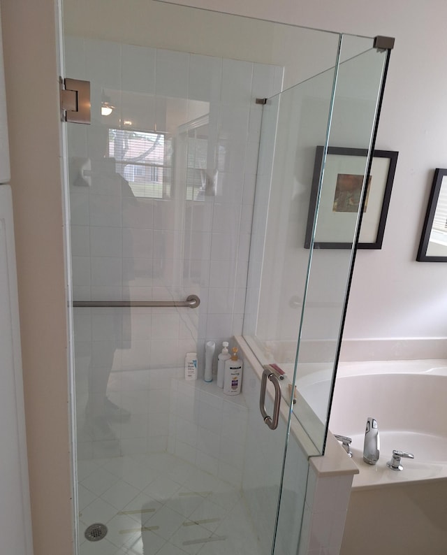 full bathroom featuring a garden tub and a stall shower