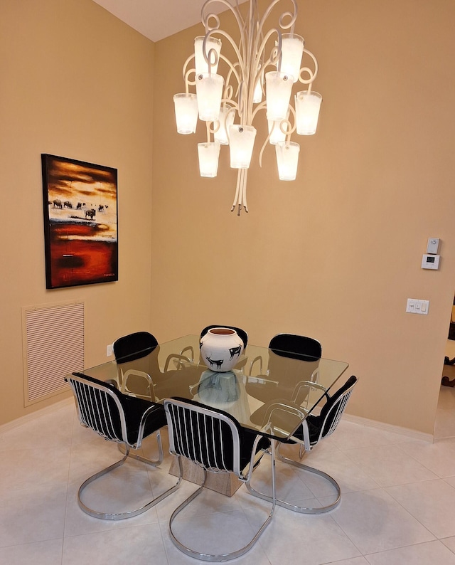 dining area with tile patterned flooring, visible vents, baseboards, and an inviting chandelier