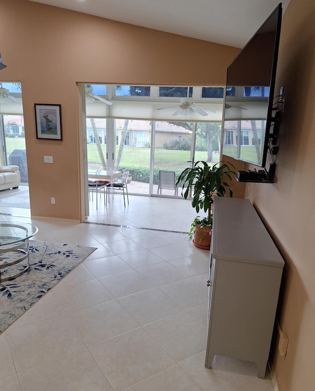 hallway featuring light tile patterned floors and lofted ceiling