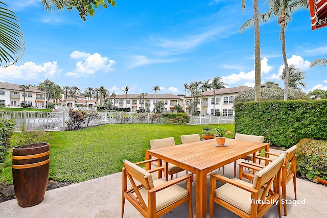 view of patio with a residential view, outdoor dining space, and fence