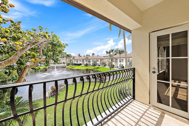 balcony featuring a water view and a residential view