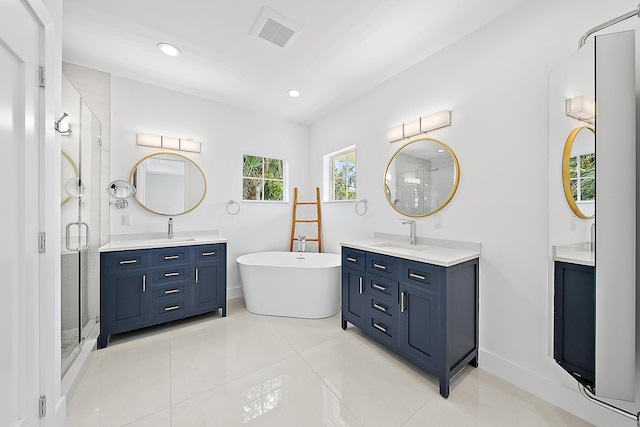 bathroom with tile patterned flooring, visible vents, a shower stall, and a sink