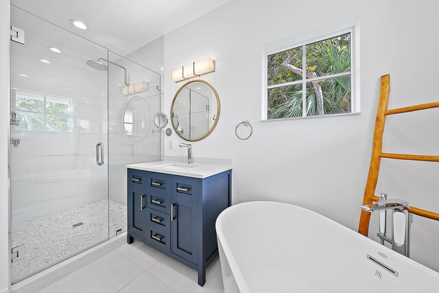 bathroom with vanity, a freestanding tub, recessed lighting, a stall shower, and tile patterned floors