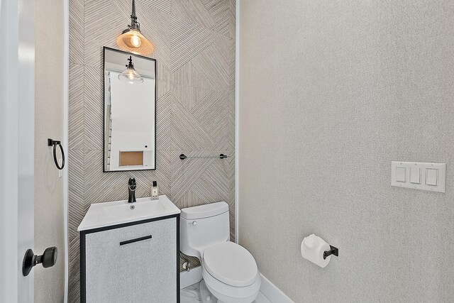 bathroom featuring toilet and vanity