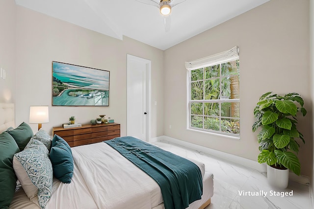 bedroom featuring a ceiling fan, baseboards, and marble finish floor