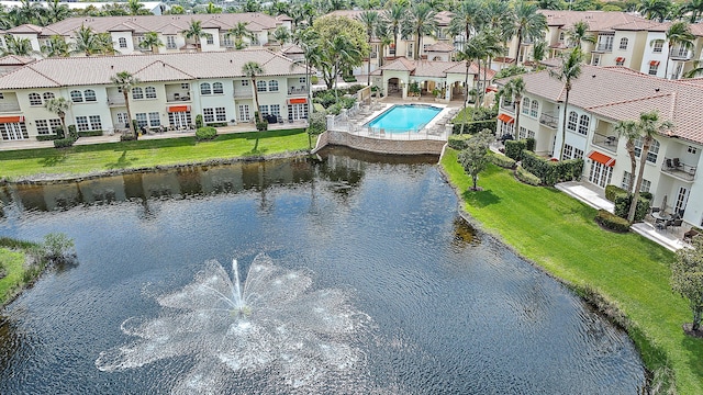 drone / aerial view with a residential view and a water view