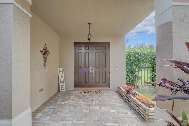 view of exterior entry with stucco siding