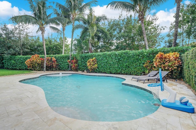 view of swimming pool featuring a patio, a fenced in pool, and a fenced backyard