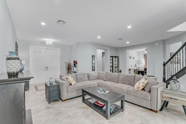 living room featuring recessed lighting, visible vents, and stairs