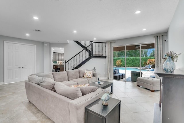 living room with visible vents, baseboards, stairway, light tile patterned floors, and recessed lighting