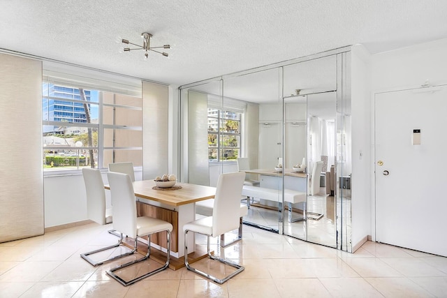 dining room with a textured ceiling and light tile patterned flooring