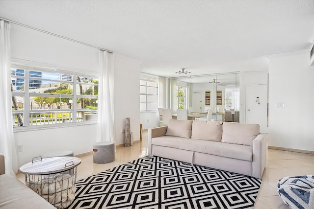 living area with light tile patterned floors, baseboards, and a textured ceiling