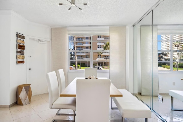 dining space featuring baseboards, a textured ceiling, and light tile patterned flooring