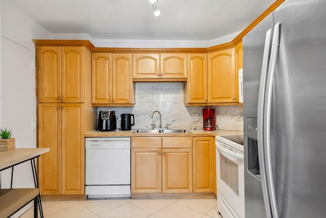 kitchen featuring white appliances, light tile patterned floors, a sink, decorative backsplash, and light countertops