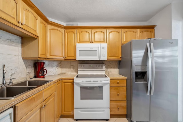 kitchen featuring white appliances, visible vents, a sink, light countertops, and tasteful backsplash