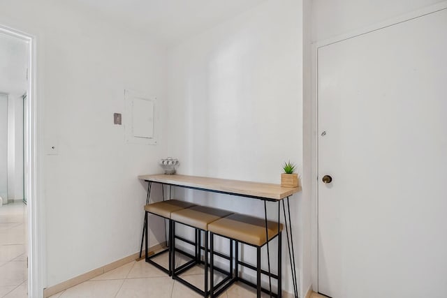 interior space featuring light tile patterned floors and baseboards