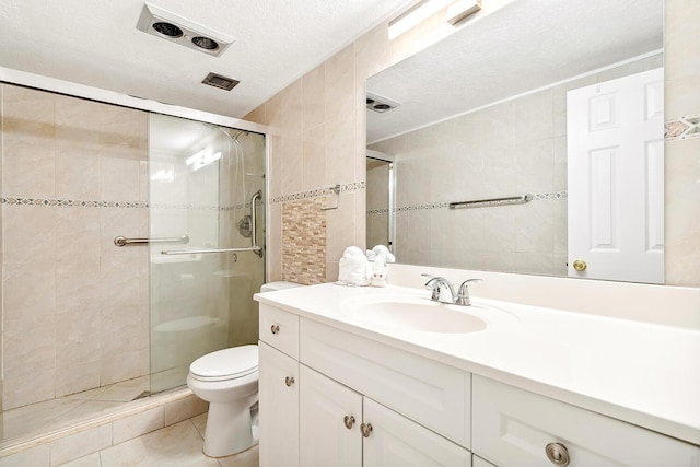 full bathroom with vanity, a textured ceiling, tile walls, and a shower stall