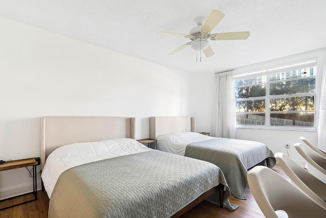 bedroom featuring wood finished floors and a ceiling fan