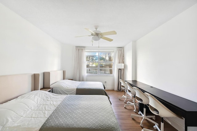 bedroom with a ceiling fan and wood finished floors