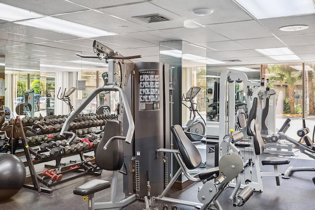 workout area with visible vents and a paneled ceiling