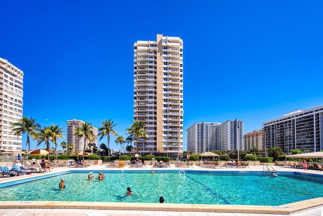 pool with a patio area and a view of city