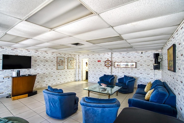 living room with tile patterned floors, a paneled ceiling, and visible vents