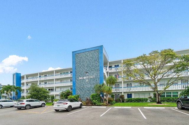 view of building exterior featuring uncovered parking