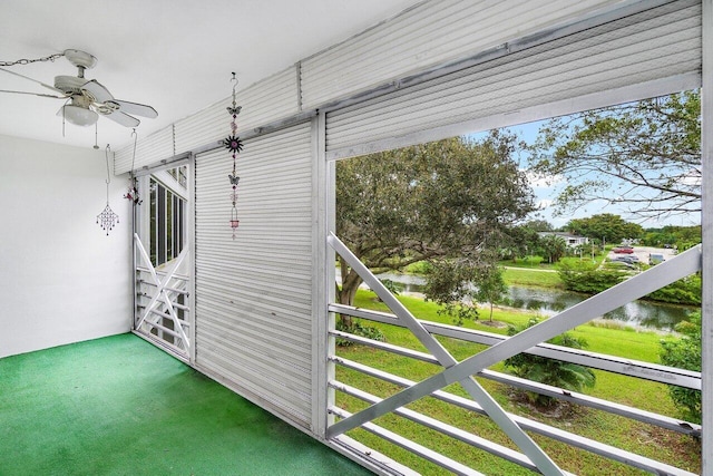 exterior space with a water view and ceiling fan