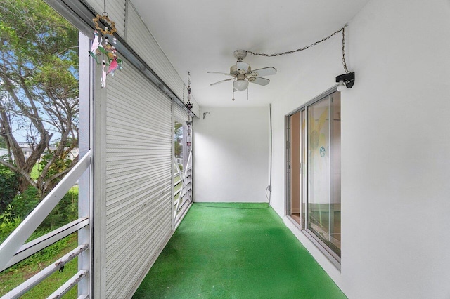 unfurnished sunroom with a ceiling fan