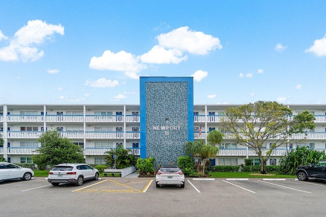 view of building exterior featuring uncovered parking