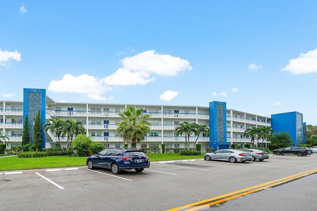 view of property featuring uncovered parking