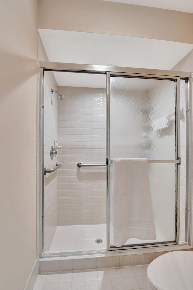 full bathroom with a shower stall and toilet