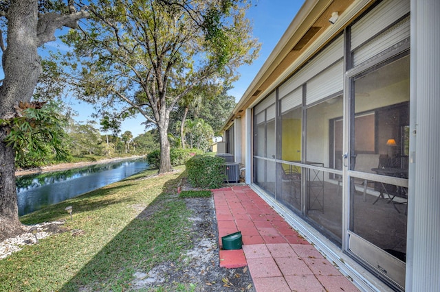 view of yard with a water view and a sunroom