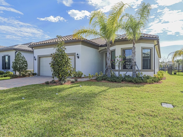 view of front of house featuring stucco siding, a tiled roof, an attached garage, and decorative driveway