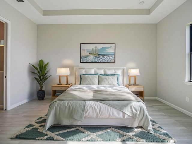 bedroom with baseboards and wood finished floors