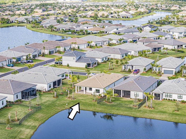 drone / aerial view featuring a residential view and a water view