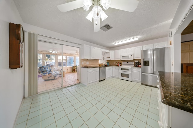 kitchen featuring light tile patterned flooring, visible vents, white cabinets, appliances with stainless steel finishes, and ceiling fan