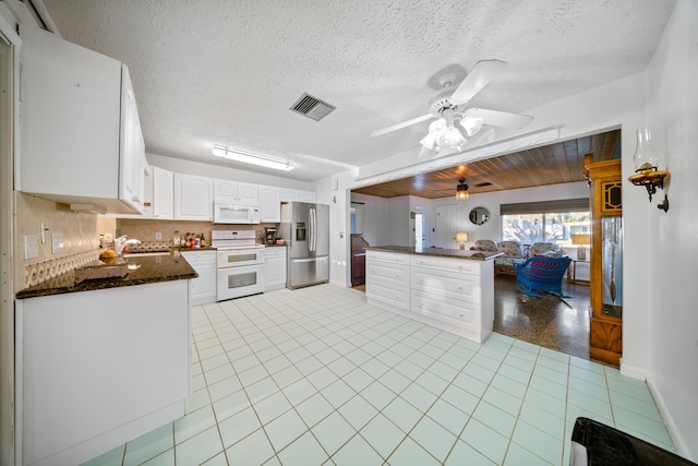 kitchen with backsplash, a ceiling fan, white appliances, visible vents, and white cabinets