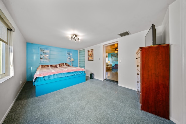 bedroom with speckled floor, baseboards, and visible vents