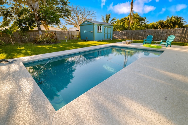 view of pool with an outdoor structure, a fenced backyard, a fenced in pool, and a yard