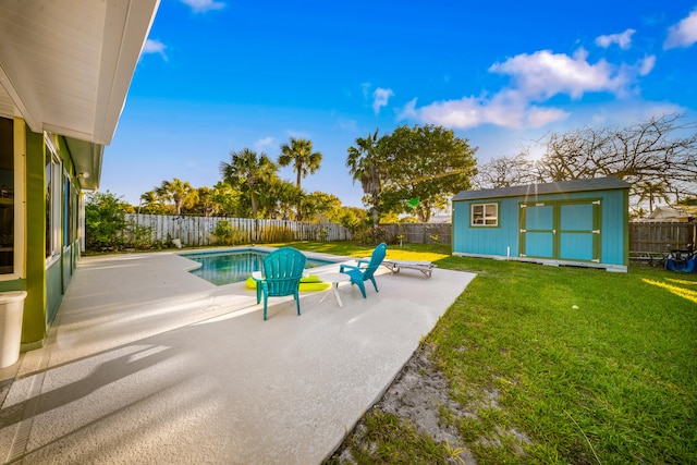 view of swimming pool featuring a lawn, a fenced in pool, a fenced backyard, and a patio area