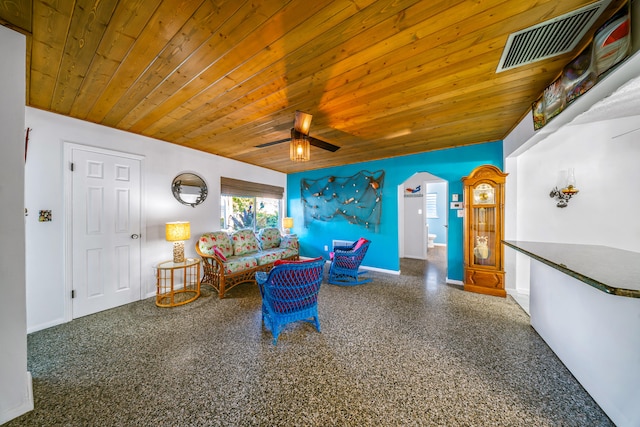living area featuring visible vents, baseboards, ceiling fan, arched walkways, and wood ceiling